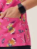 Workin Gear Woman wearing a pink Christmas scrub top  