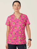 Workin Gear Woman wearing a pink Christmas scrub top  