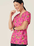 Workin Gear Woman wearing a pink Christmas scrub top  