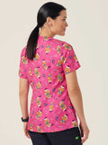 Workin Gear Woman wearing a pink Christmas scrub top  