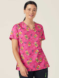 Workin Gear Woman wearing a pink Christmas scrub top  