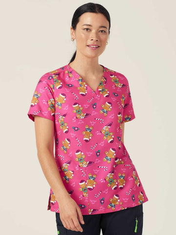 Workin Gear Woman wearing a pink Christmas scrub top  