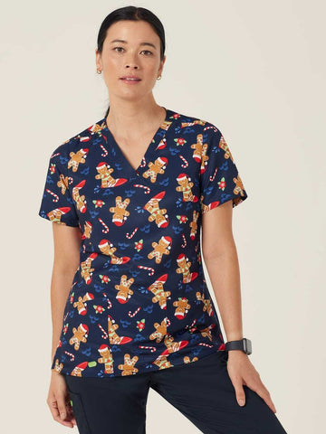 Woman wearing a navy blue christmas Scrub Top