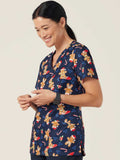 Woman wearing a navy blue christmas Scrub Top